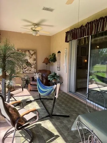 a view of a room with furniture and a window