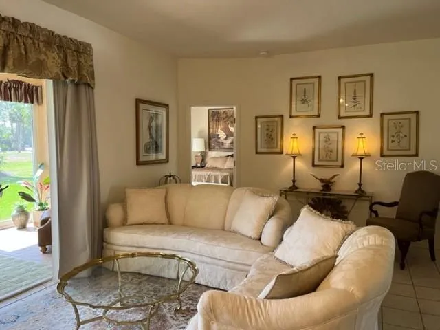 a living room with furniture and painting on the wall