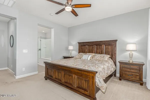 a bedroom with a bed and a chandelier