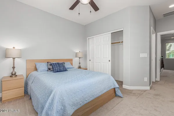 a bedroom with a bed and a lamp