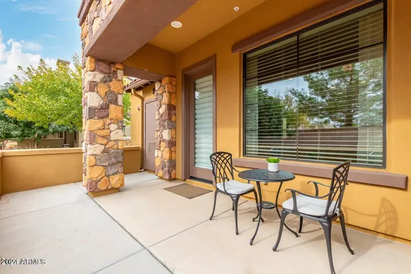 a balcony with furniture and a window