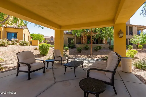 a view of a patio with table and chairs and potted plants