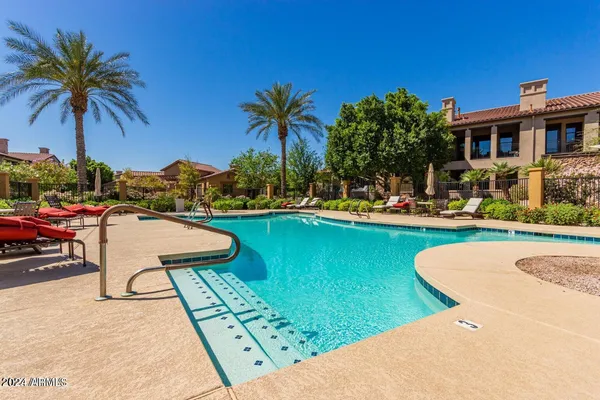 a view of swimming pool with outdoor seating and a garden