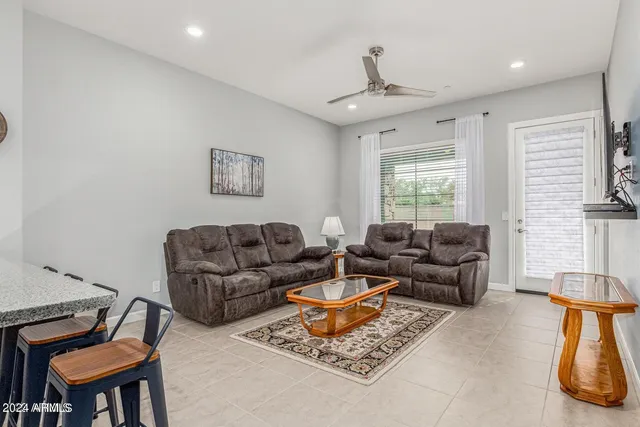 a living room with furniture a rug and a window