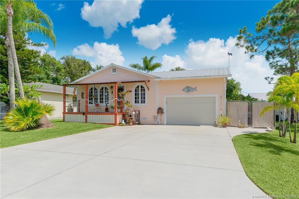 a front view of a house with porch and garden