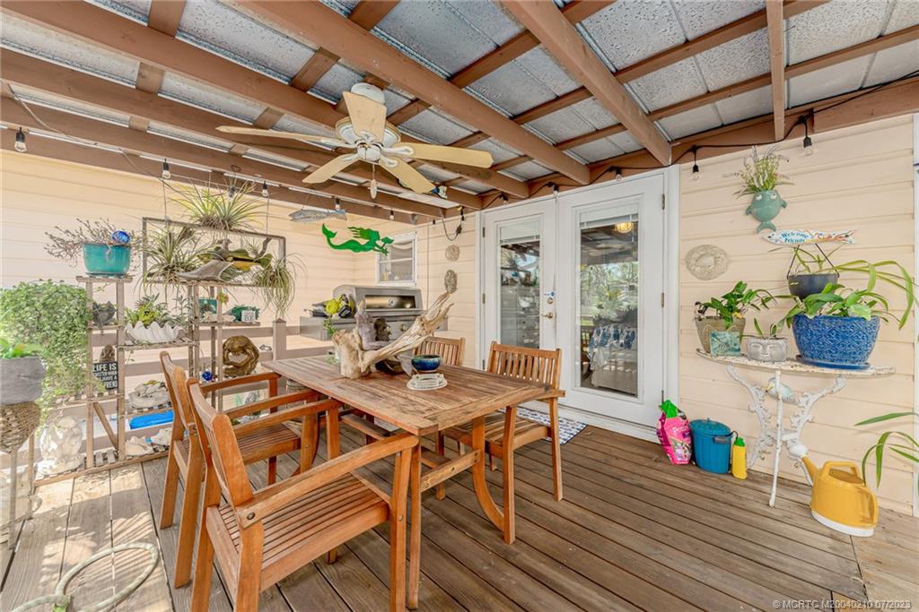 4171 Southeast Robert Loop Road Stuart, FL 34997 - Photo 16 of 27 a view of a dining room with furniture wooden floor and a potted plant