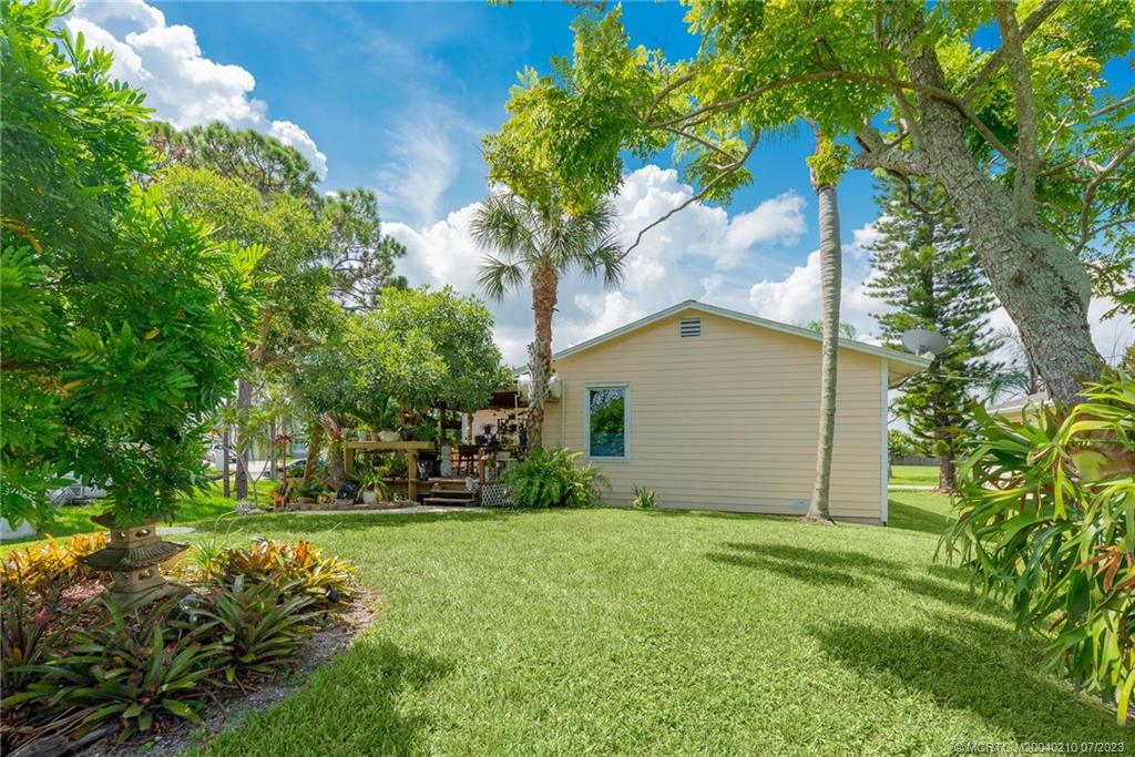 4171 Southeast Robert Loop Road Stuart, FL 34997 - Photo 21 of 27 a house view with a garden space