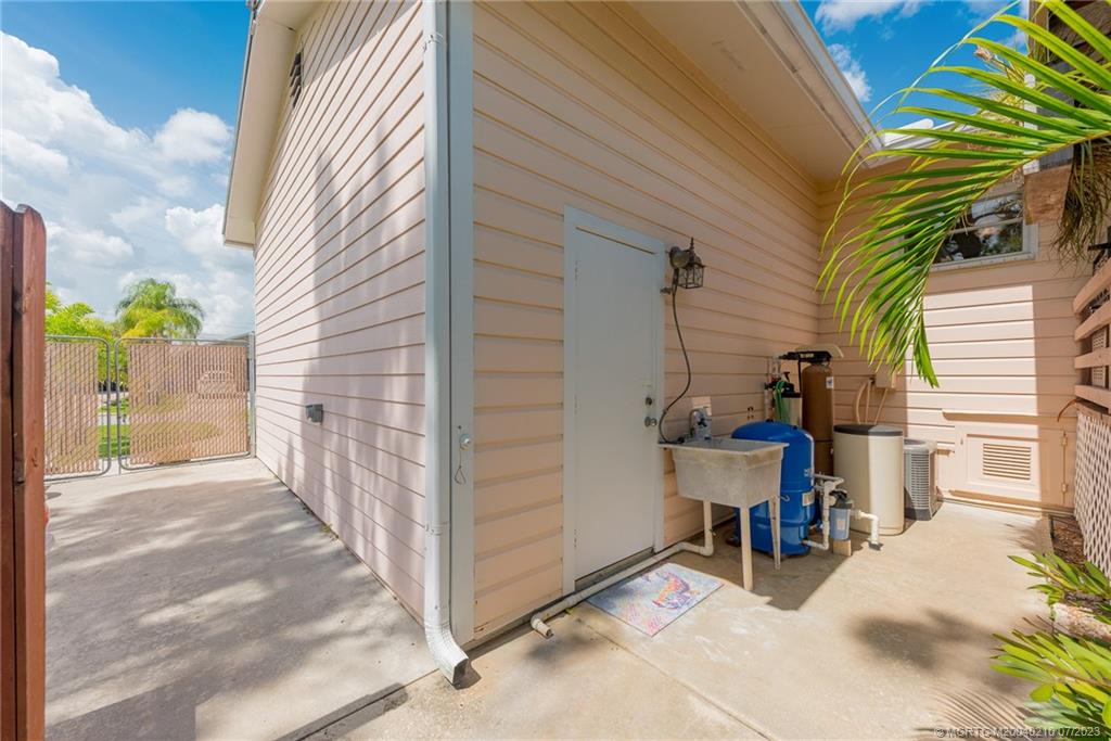 4171 Southeast Robert Loop Road Stuart, FL 34997 - Photo 23 of 27 a view of a house with backyard and sitting area