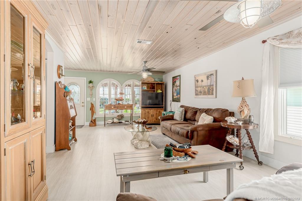 4171 Southeast Robert Loop Road Stuart, FL 34997 - Photo 5 of 27 a living room with furniture kitchen view and a window