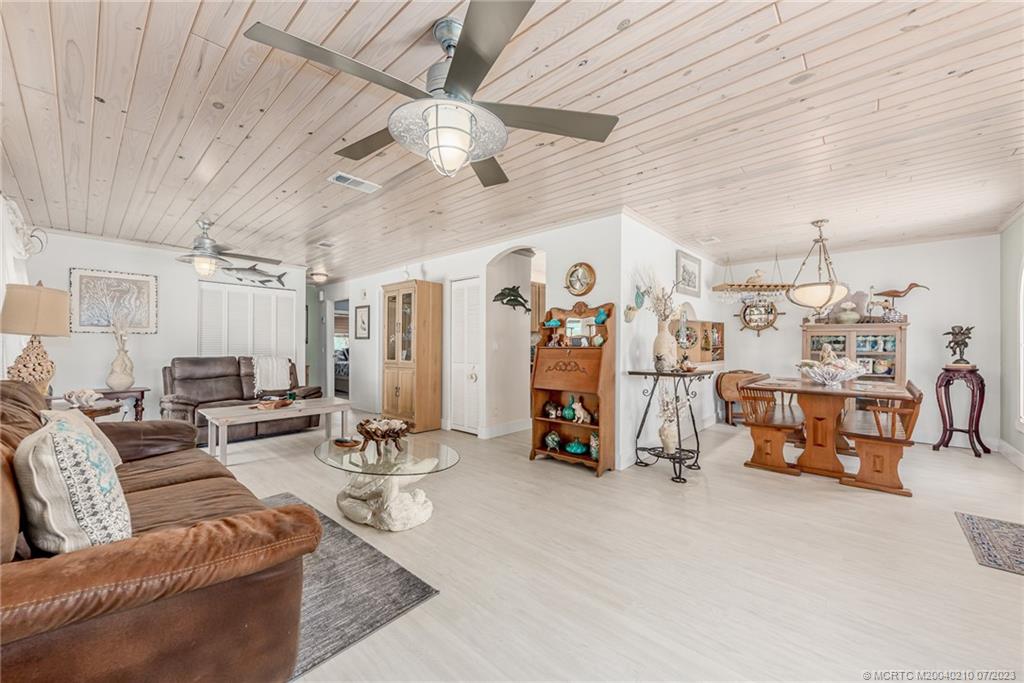 4171 Southeast Robert Loop Road Stuart, FL 34997 - Photo 9 of 27 a living room with furniture and a chandelier