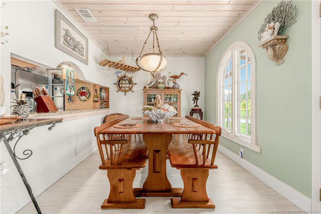 4171 Southeast Robert Loop Road Stuart, FL 34997 - Photo 10 of 27 a view of a dining room with furniture window and outside view