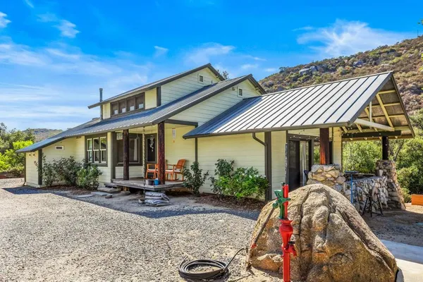 a view of a patio with table and chairs under an umbrella