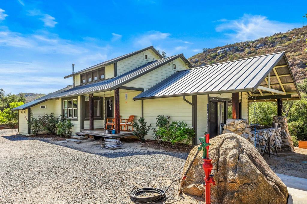a view of a patio with table and chairs under an umbrella
