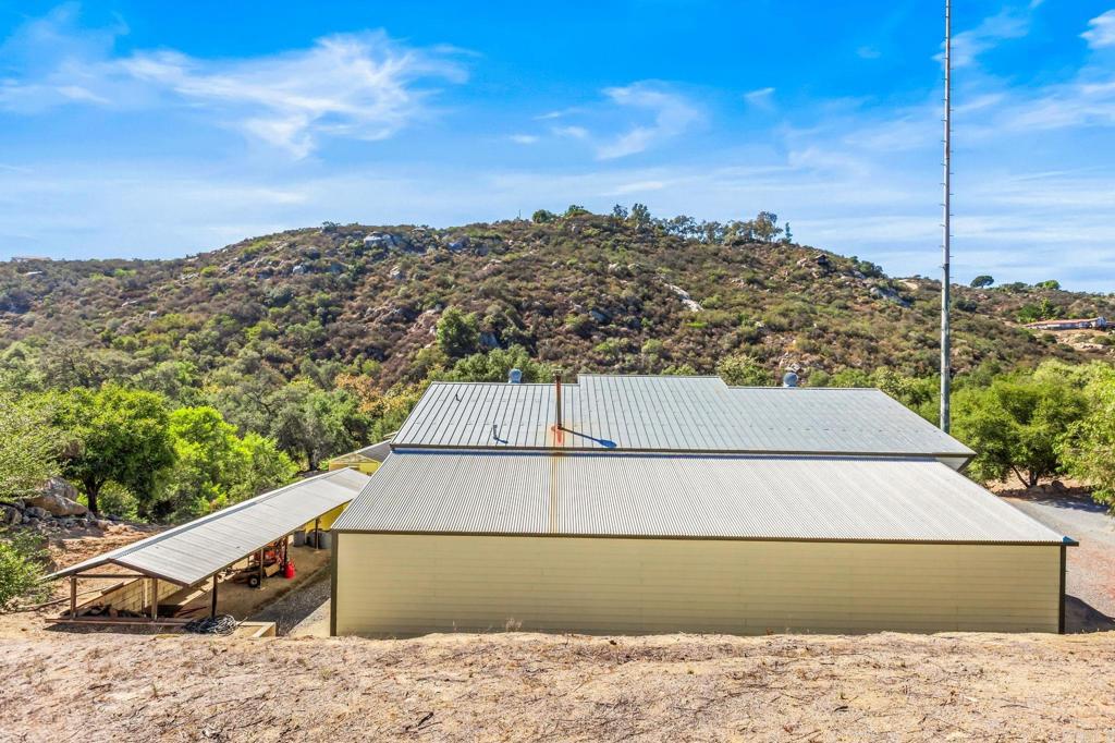 29533 Anthony Road Valley Center, CA 92082 - Photo 12 of 71 Rear view of garage including the roofed shed along back of garage building.