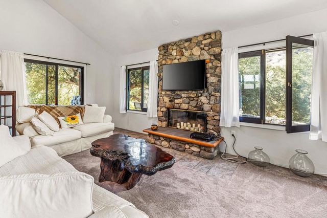 a kitchen with stainless steel appliances a stove a sink and a refrigerator
