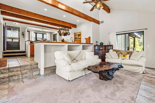 a dining hall with stainless steel appliances kitchen island a stove a table and chairs in it