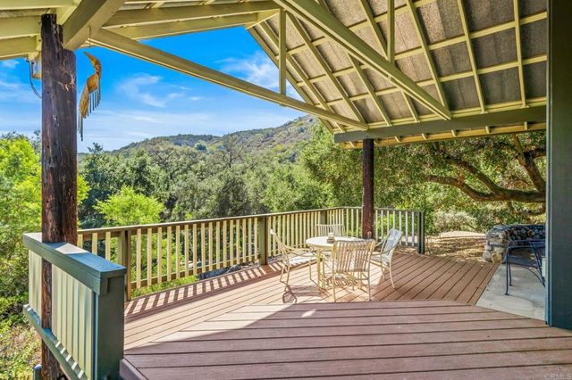 a view of a yard with wooden fence