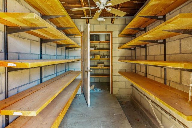 an aerial view of a house with a mountain