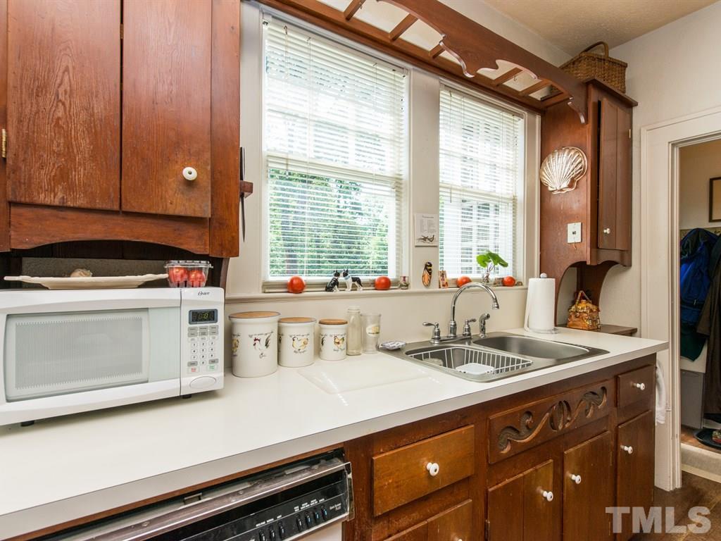 2320 Anderson Drive Raleigh, NC 27608 - Photo 11 of 25 a kitchen with a sink and cabinets