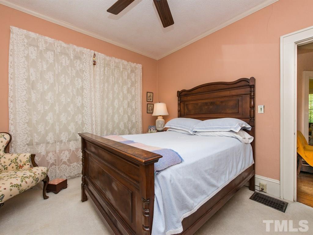 2320 Anderson Drive Raleigh, NC 27608 - Photo 16 of 25 a bedroom with a bed and a chandelier fan