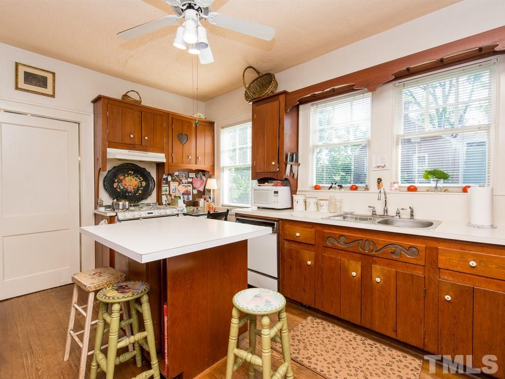 2320 Anderson Drive Raleigh, NC 27608 - Photo 9 of 25 a kitchen with a sink appliances cabinets and a large window