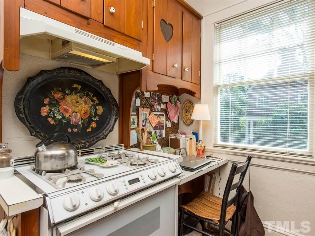 2320 Anderson Drive Raleigh, NC 27608 - Photo 10 of 25 a kitchen with a stove a sink and a table