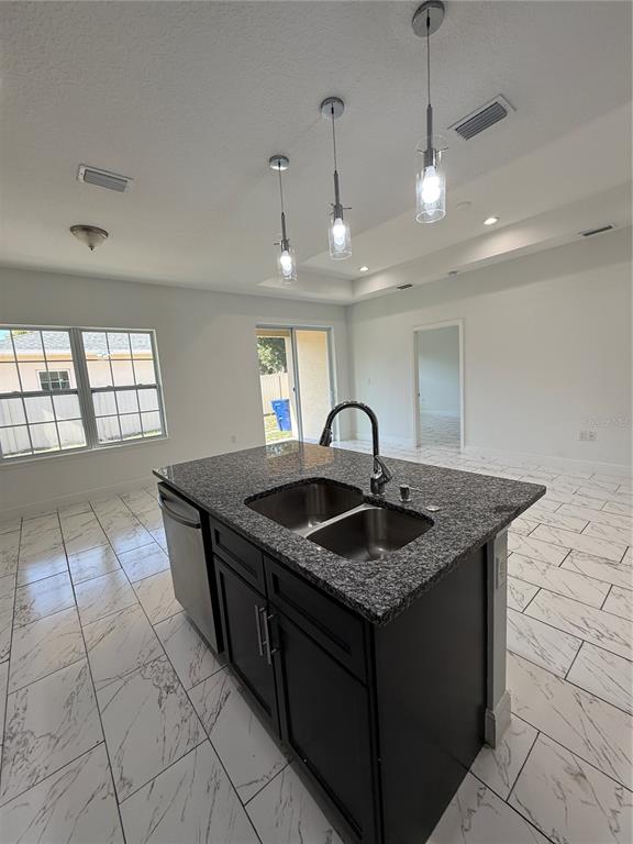 2314 Apache Avenue Kissimmee, FL 34744 - Photo 11 of 29 a kitchen with granite countertop a sink a counter top space and cabinets