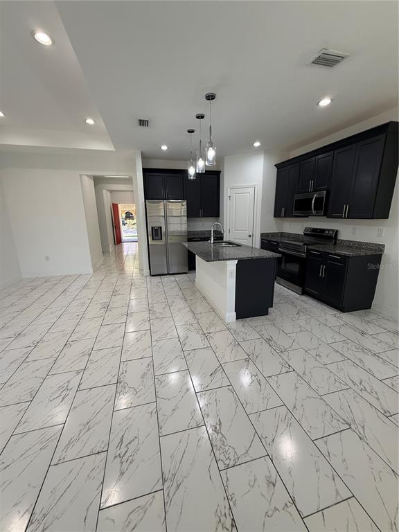 2314 Apache Avenue Kissimmee, FL 34744 - Photo 13 of 29 a living room with patio furniture and a flat screen tv