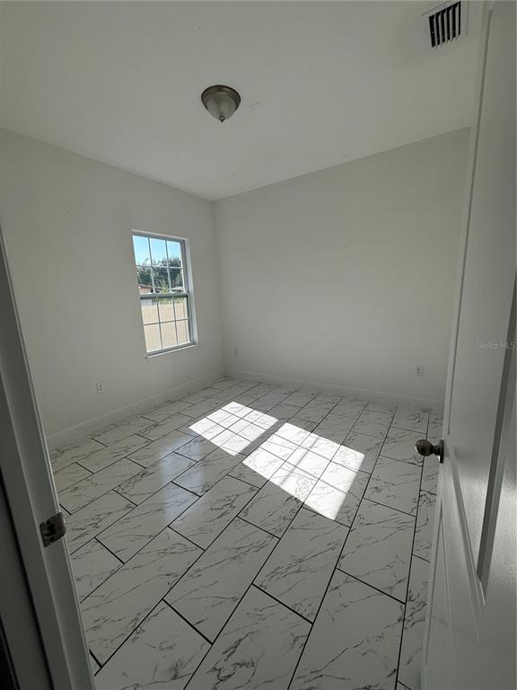 2314 Apache Avenue Kissimmee, FL 34744 - Photo 22 of 29 a view of wooden floor and windows in a room