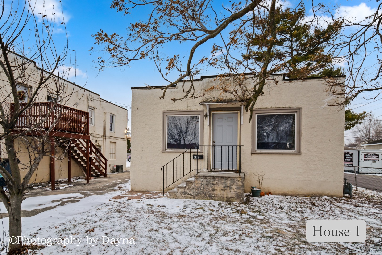 242 West Jeffery Street Kankakee, IL 60901 - Photo 7 of 39 a view of a grey house with a tree