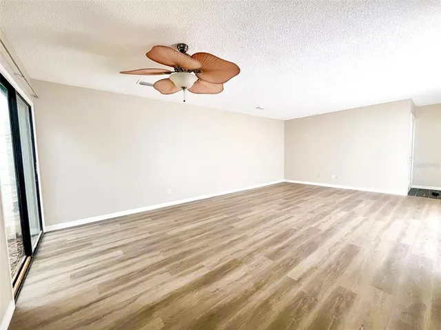 a view of a room with wooden floor and white walls