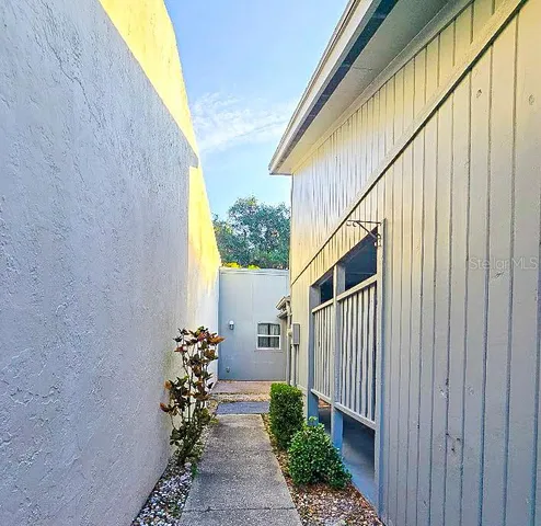 a path view of a house with wooden fence