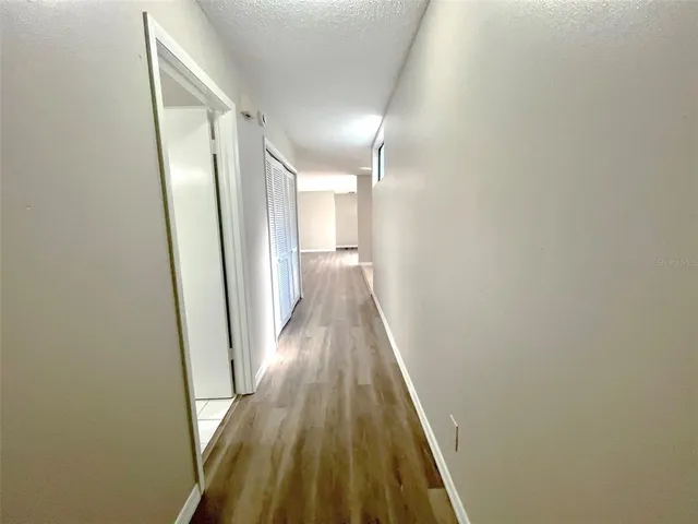 a view of a hallway with wooden floor