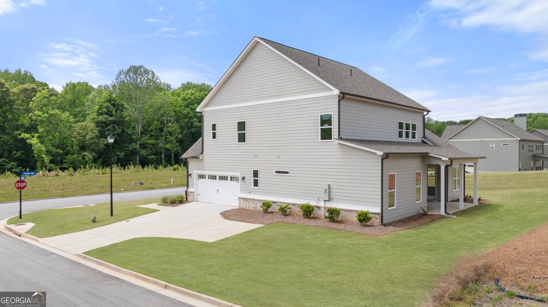 15 Overview Court Hoschton, GA 30548 - Photo 37 of 43 a front view of house with yard and trees in the background