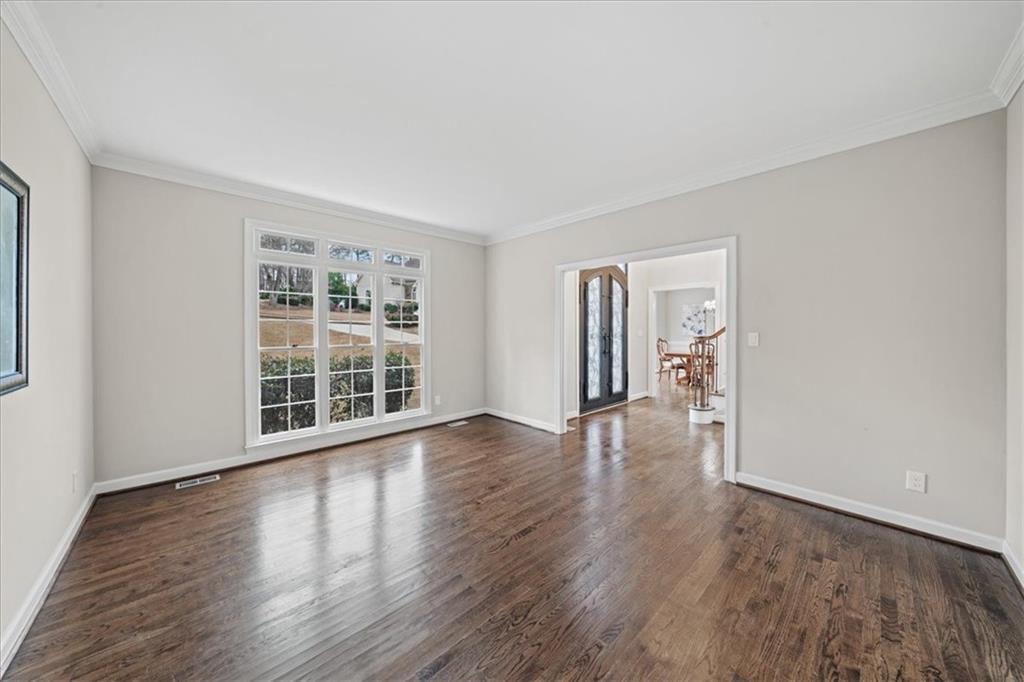 605 Pine Trail Pointe Roswell, GA 30075 - Photo 11 of 76 a view of an empty room with wooden floor and windows