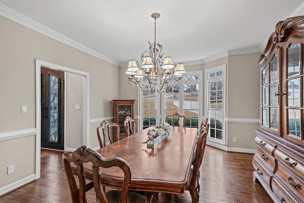 605 Pine Trail Pointe Roswell, GA 30075 - Photo 13 of 76 a view of a dining room with furniture a chandelier and wooden floor