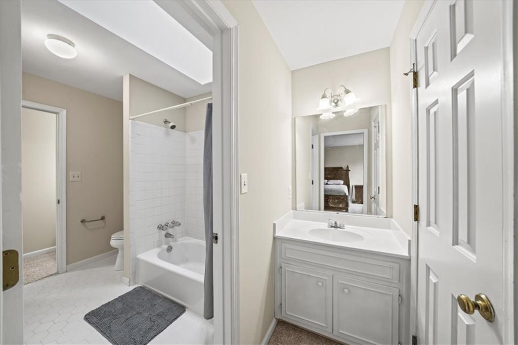 605 Pine Trail Pointe Roswell, GA 30075 - Photo 53 of 76 a bathroom with a tub a sink and mirror