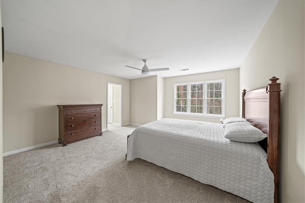 605 Pine Trail Pointe Roswell, GA 30075 - Photo 54 of 76 a spacious bedroom with a bed and a fireplace