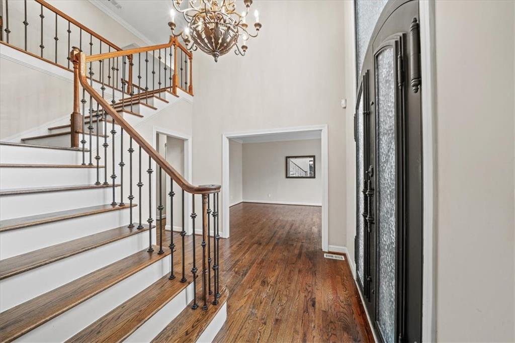 605 Pine Trail Pointe Roswell, GA 30075 - Photo 9 of 76 a view of staircase with wooden floor and a chandelier
