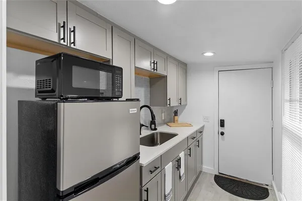 a kitchen with a sink and a granite counter top