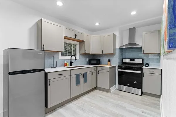 a kitchen with a sink cabinets and window