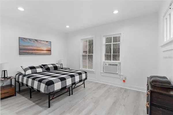 a kitchen with stainless steel appliances a stove a refrigerator and a dining table