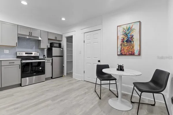 a kitchen with a stove a refrigerator and a sink