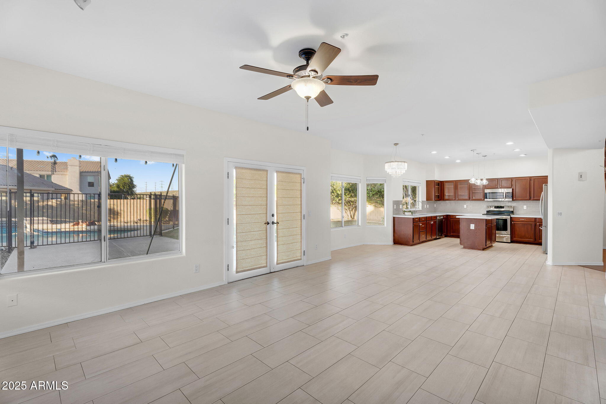 14566 North 100th Place Scottsdale, AZ 85260 - Photo 9 of 34 a view of a livingroom with a furniture ceiling fan and kitchen view