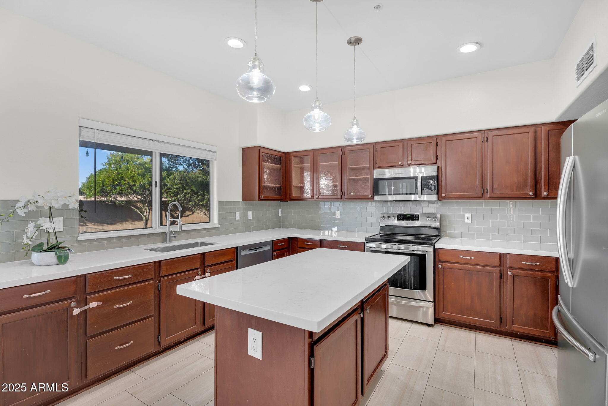 14566 North 100th Place Scottsdale, AZ 85260 - Photo 11 of 34 a kitchen with a stove sink and cabinets