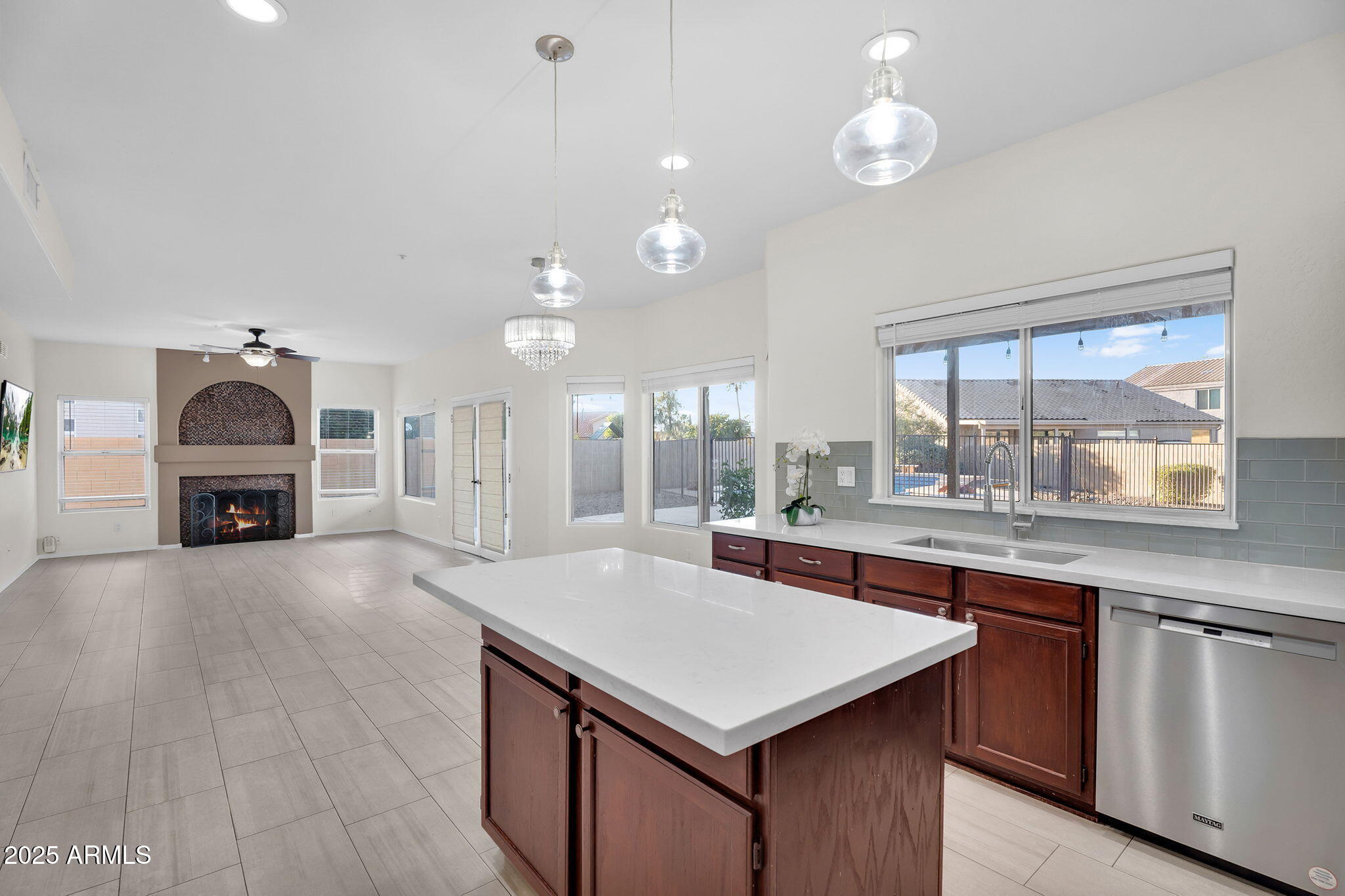 14566 North 100th Place Scottsdale, AZ 85260 - Photo 13 of 34 a kitchen with kitchen island a sink appliances and a counter top space
