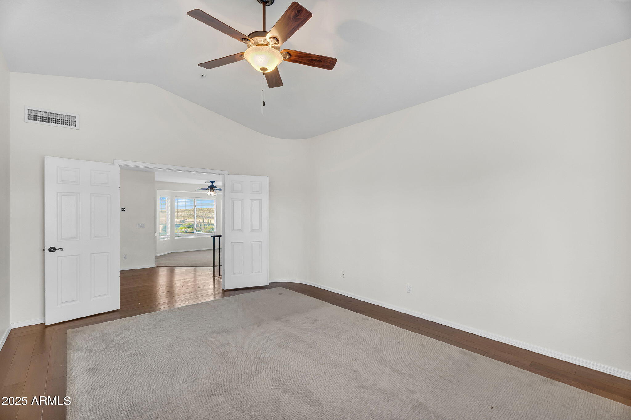 14566 North 100th Place Scottsdale, AZ 85260 - Photo 18 of 34 an empty room with chandelier fan and windows