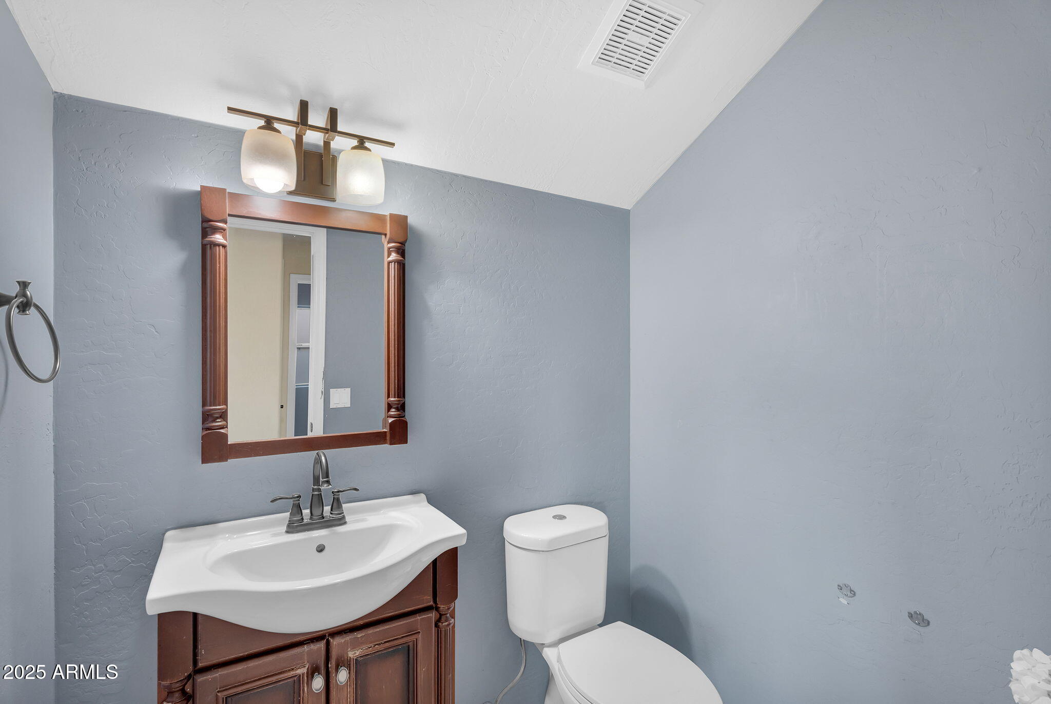 14566 North 100th Place Scottsdale, AZ 85260 - Photo 26 of 34 a bathroom with a toilet sink and mirror