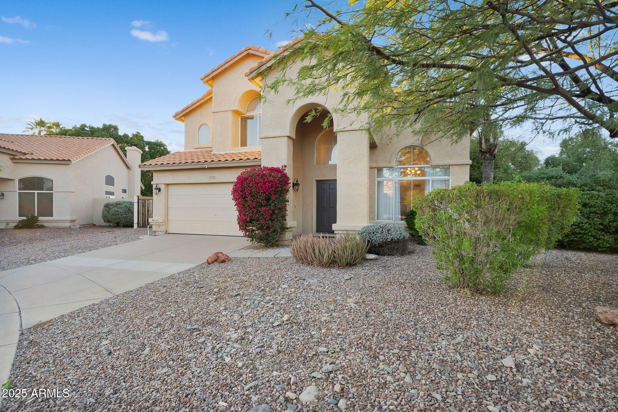 14566 North 100th Place Scottsdale, AZ 85260 - Photo 2 of 34 a front view of a house with garden
