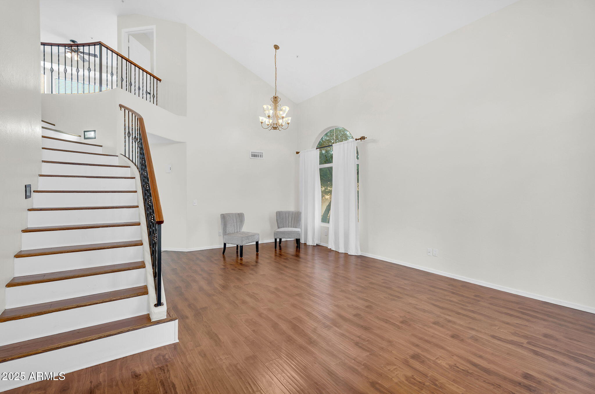 14566 North 100th Place Scottsdale, AZ 85260 - Photo 3 of 34 a view of a livingroom with wooden floor and stairs